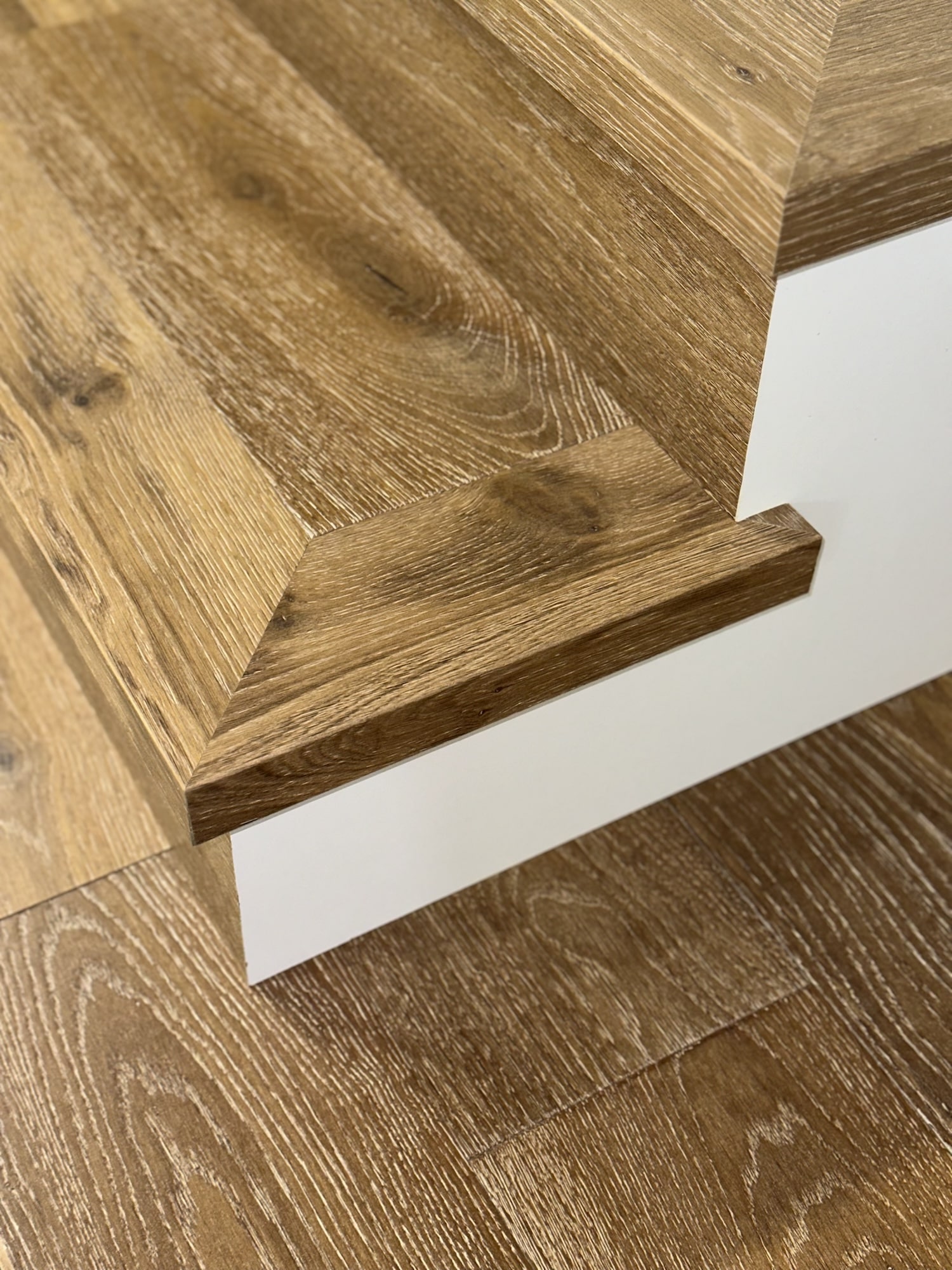 Custom stair nosing with non-slip features, perfectly color-matched to luxury vinyl plank flooring for enhanced safety and aesthetic continuity